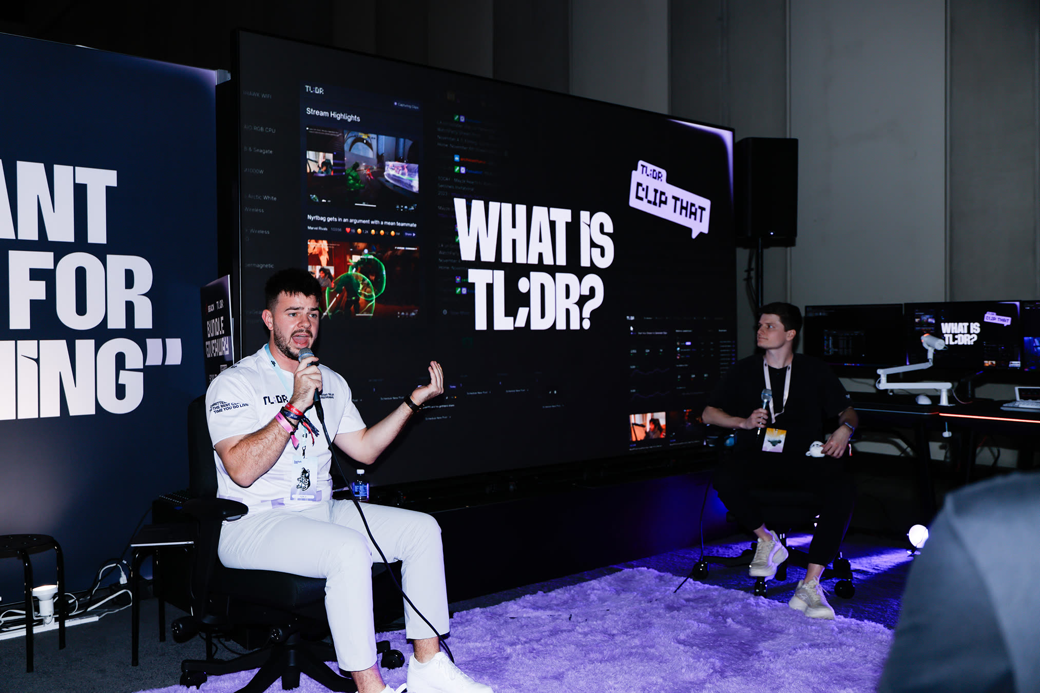 TL;DR founders presenting on the TwitchCon booth stage, with the product and 'What is TL;DR?' on the screen wall behind them.